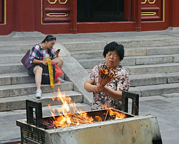 Beijing - Lighting incense at the Tibetan Temple