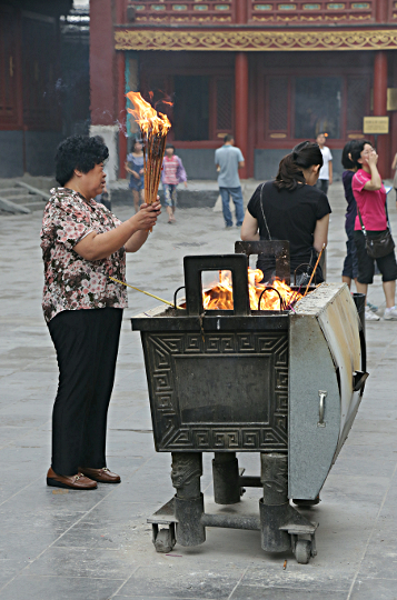 Beijing - Lighting incense at the Tibetan Temple