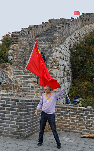 Great Wall of China at Mutianyu
 - Srategically placed Chinese flags with which tourists may pose. - An additional source of income for salespeople who appreciate a small gratuity for photographing you with your camera.