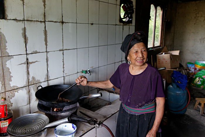 Longji Terraced Rice Paddies and the Yao People - Yao Cook in her guesthouse kitchen