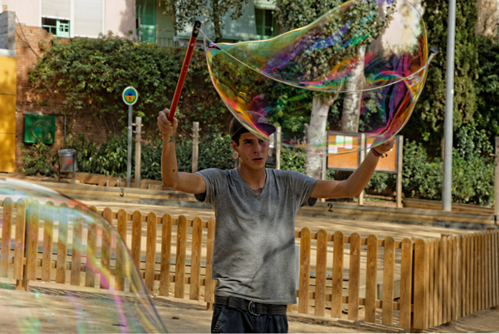 Gaudi's Sagrada Familia in Barcelona - Bubble blower in the park next to cathederal