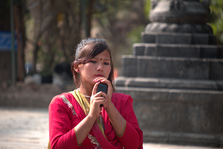 Nepal - Girl Cradling Mobile Phon