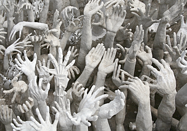 Worship in Thailand - Hands from Hell at Wat Rong Khun, the White Temple, in Chiang Rei