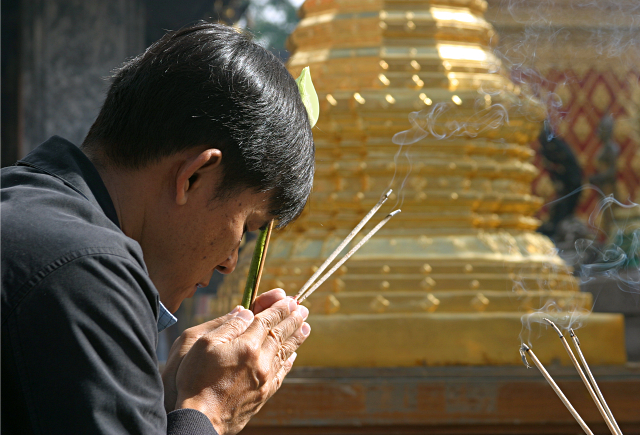 Worship in Thailand - Incense in Phrathat Doi Suthep Temple in Chiang Mai