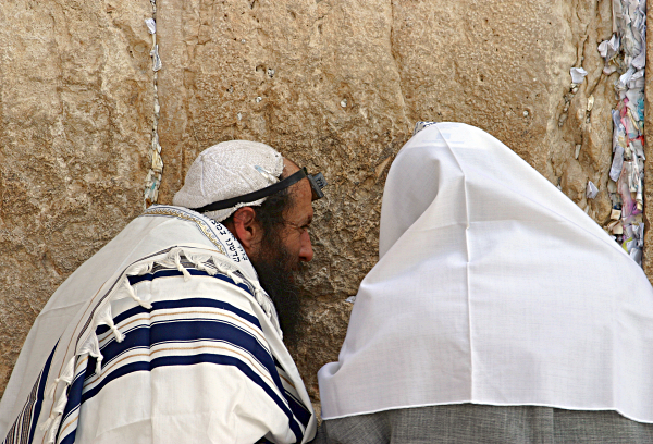 Yerushalayim - Jerusalem, the Kotel and the Temple Mount -- Har haBayit - A beggar at the Kotel, Western Wall under a Talith, Prayer Shawl, in Tefilin