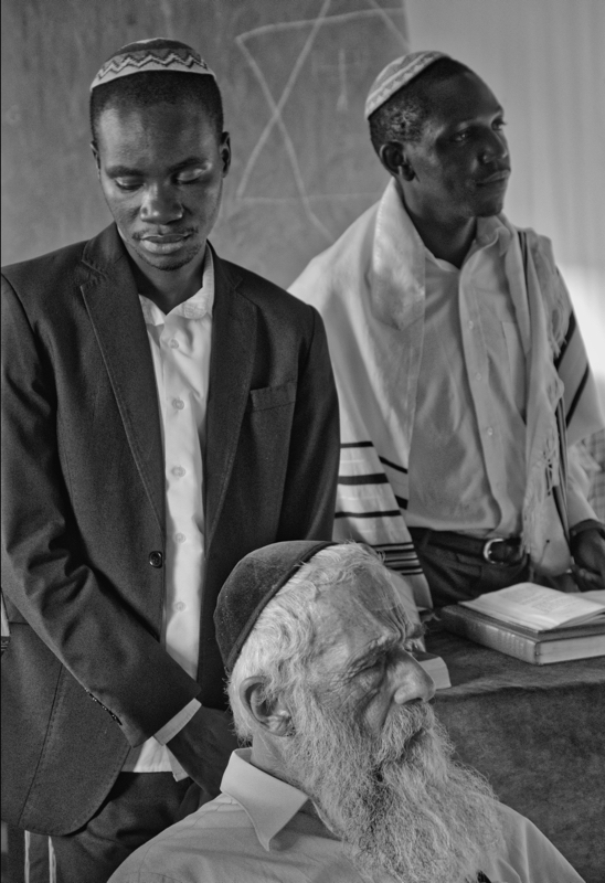 A Spiritual Experience in Africa - Moshe Yashiira leading the afternoon prayers. Rabbi Yonatan Segal medidating in prayer.