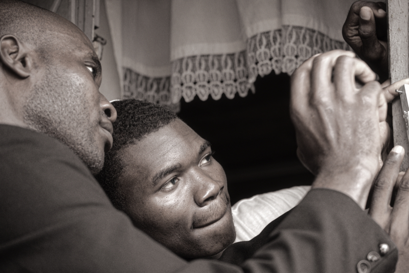 A Spiritual Experience in Africa - Yisrael Amir and Belshazar, of the Bnei Yeshuroun community in Cameroon, affixing a  to the door of house they use for study and prayer in the major port city of Douala, Cameroon. There are 2 more such community centres in Yaounde and Sa'a.