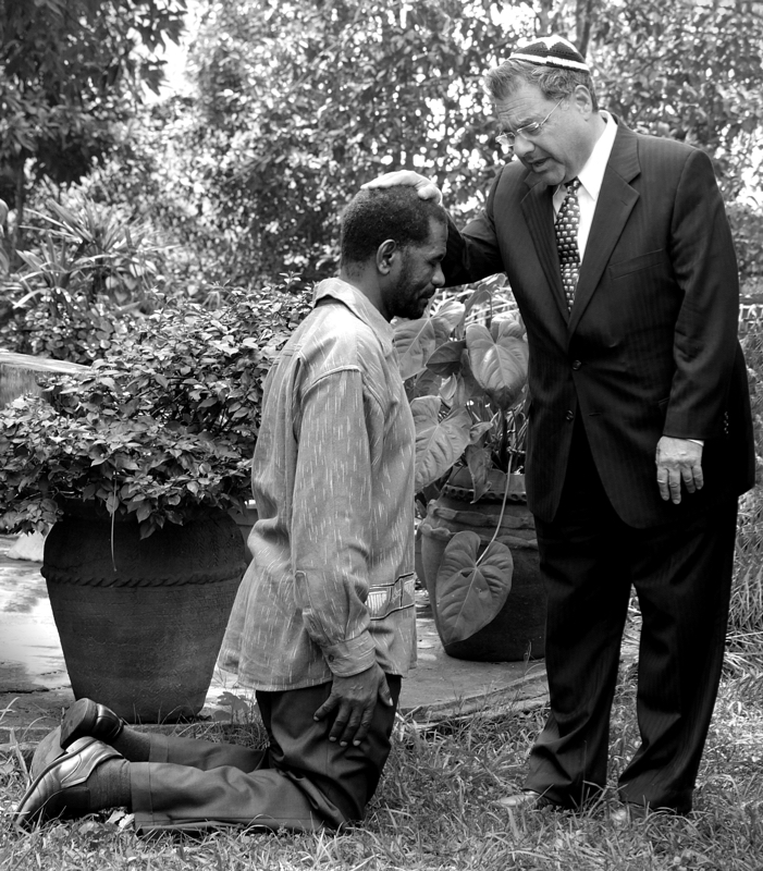 A Spiritual Experience in Africa - Rabbi Riskin, a cohen, blessing a professor of divinity in the latter's yard in a wealthy gated community in Nairobi, Kenya. The professor's wife, an endochronologist at the main Kenyan teaching hospital, also runs a quail farm in the large yard adjacent to their home. She is reputed to raise the most delicious quail in Kenya. We were there to perform  for the tiny, local Jewish community.